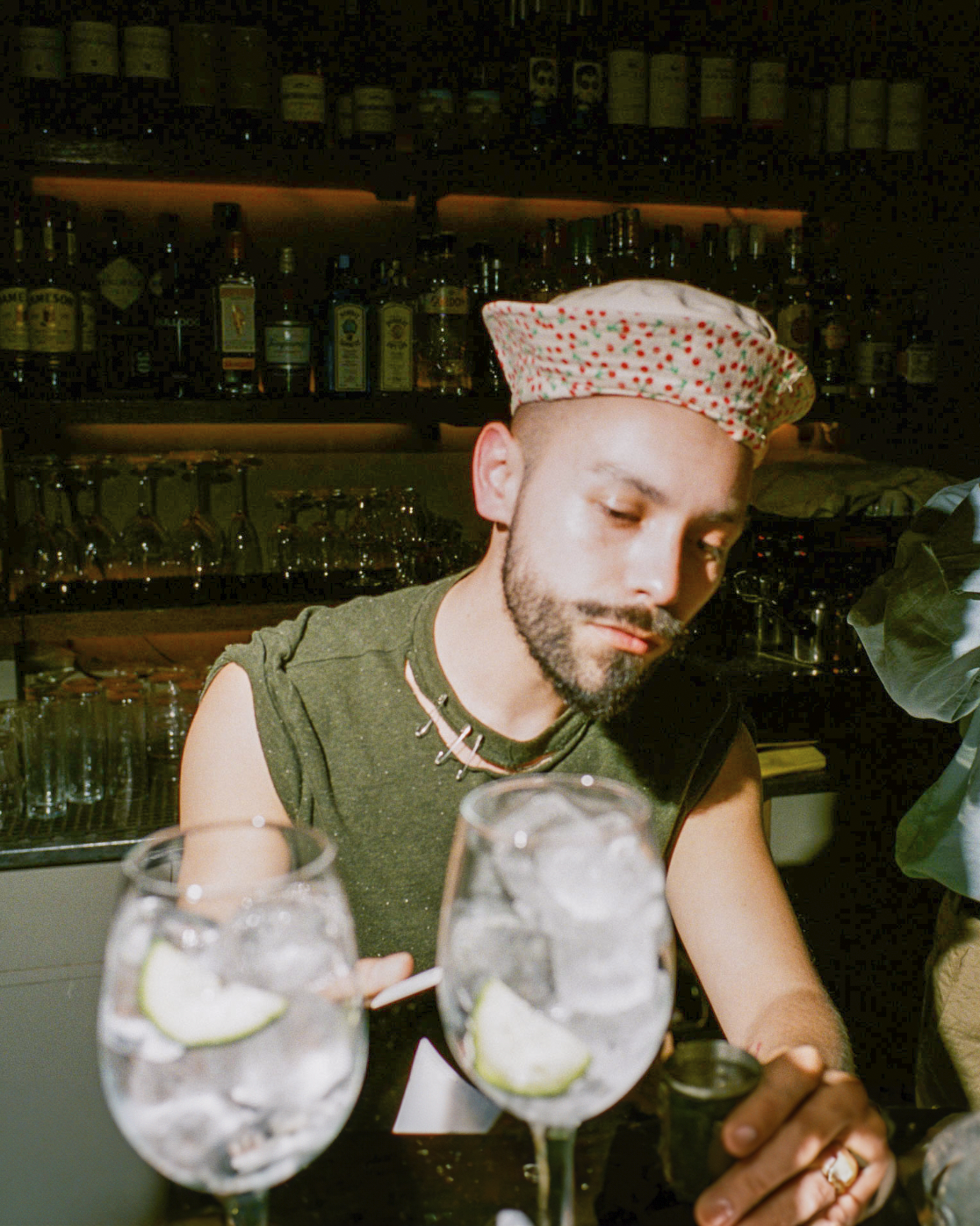 Jon Jacobsen working at a bar, showcasing his diverse career and creative mindset, wearing his artistic hat.