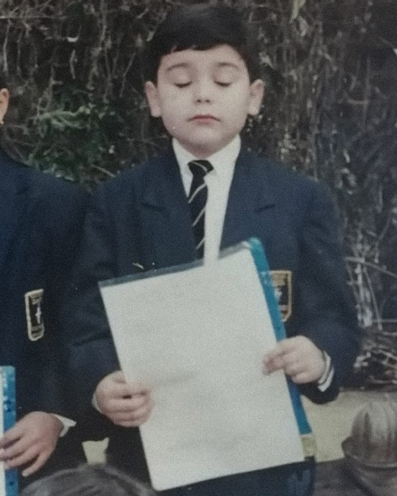 A young Jon Jacobsen holding a speech in school, showing his early commitment to connecting with others.